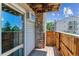 Cozy balcony featuring wood decking, stone accents, and scenic views of the neighborhood at 381 S Ames St # E104, Lakewood, CO 80226