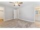 Large bedroom featuring plush carpeting, two closets, and an attached bathroom at 381 S Ames St # E104, Lakewood, CO 80226