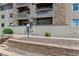 Exterior view of multi-story building with stone accents and private balconies at 381 S Ames St # E104, Lakewood, CO 80226
