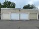 Individual garages with various door styles provide secure parking for each unit at 381 S Ames St # E104, Lakewood, CO 80226