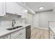 This kitchen has stainless steel appliances, light wood flooring, and bright white cabinets at 381 S Ames St # E104, Lakewood, CO 80226