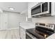 Stylish kitchen featuring stainless steel appliances, white cabinetry, and a modern design at 381 S Ames St # E104, Lakewood, CO 80226