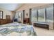 Comfortable bedroom with a vaulted ceiling, large windows, and charming furnishings providing a relaxing retreat at 14064 E Whitaker Dr, Aurora, CO 80015