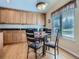 Eat-in kitchen featuring a breakfast table, sleek countertops, and plenty of cabinetry at 14064 E Whitaker Dr, Aurora, CO 80015