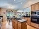 Spacious kitchen featuring an island with a gas cooktop, sleek countertops, and wood floors at 14064 E Whitaker Dr, Aurora, CO 80015