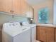 Well-organized laundry room with modern washer and dryer, storage cabinets, and a convenient sink at 14064 E Whitaker Dr, Aurora, CO 80015
