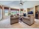 Cozy living room with a fireplace, comfortable seating, and bright natural lighting at 14064 E Whitaker Dr, Aurora, CO 80015