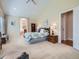 Open main bedroom with a large bed, vaulted ceiling, and an ensuite bathroom at 14064 E Whitaker Dr, Aurora, CO 80015