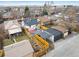 Aerial view of a charming home with a patio, fenced yard, and detached garage in a vibrant neighborhood with mountain views at 1282 S Sherman St, Denver, CO 80210
