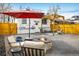 Backyard boasts a stone fire pit, shade umbrella, and outdoor seating beneath a pergola at 1282 S Sherman St, Denver, CO 80210