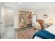 Bedroom view with a book shelf, comfortable chair, and a view to another room at 1282 S Sherman St, Denver, CO 80210