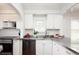 Bright kitchen with stainless steel countertops, white cabinets, and stainless steel appliances at 1282 S Sherman St, Denver, CO 80210