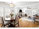 Open-concept living area featuring a dining table, fireplace, and ample natural light at 1282 S Sherman St, Denver, CO 80210