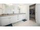 Bathroom with double vanity, granite countertop, and a large mirror at 16278 E 111Th Pl, Commerce City, CO 80022