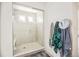 Modern bathroom with glass shower door, tiled walls, and a built-in bench at 16278 E 111Th Pl, Commerce City, CO 80022