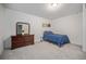 Bedroom with wood dresser and a blue bed at 16278 E 111Th Pl, Commerce City, CO 80022