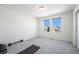 Bedroom featuring carpeted floors, two windows, a sliding closet door, and workout equipment at 16278 E 111Th Pl, Commerce City, CO 80022