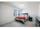 Cozy bedroom with a patterned comforter and window view at 16278 E 111Th Pl, Commerce City, CO 80022