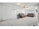 Upstairs living room featuring two leather sofas, fan, and light grey carpeting at 16278 E 111Th Pl, Commerce City, CO 80022