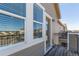 Balcony view of the city with wooden floors and white trimmed glass door entry at 11250 Florence St # 30B, Commerce City, CO 80640