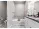 Bright bathroom with a tub, updated vanity with dual sinks, and modern fixtures at 11250 Florence St # 30B, Commerce City, CO 80640