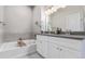 Bathroom featuring a bathtub, shower combination, and a double sink vanity at 11250 Florence St # 30B, Commerce City, CO 80640