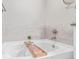 Bathtub with sleek faucet and wooden bath tray, creating a luxurious and relaxing space at 11250 Florence St # 30B, Commerce City, CO 80640
