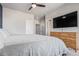 Bright bedroom featuring a large bed, natural wood dresser, and ample closet space at 11250 Florence St # 30B, Commerce City, CO 80640