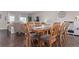 Spacious dining area with a large wooden table, ample seating, and an open layout connecting to the living area at 11250 Florence St # 30B, Commerce City, CO 80640