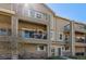 Charming condo exterior featuring private balconies and inviting landscaping at 11250 Florence St # 30B, Commerce City, CO 80640