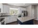 Modern kitchen with stainless steel appliances, white cabinets, island and ample counter space at 11250 Florence St # 30B, Commerce City, CO 80640