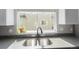Close-up of kitchen sink beneath a window with modern faucet and bright natural light at 11250 Florence St # 30B, Commerce City, CO 80640