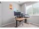 Functional office with a large window, modern desk, and dual monitor setup at 11250 Florence St # 30B, Commerce City, CO 80640