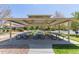 Community picnic area with multiple tables and benches under a sheltered canopy at 11250 Florence St # 30B, Commerce City, CO 80640