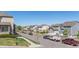 Scenic neighborhood street view with tidy homes, parked vehicles, and distant mountain scenery at 11250 Florence St # 30B, Commerce City, CO 80640