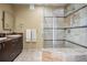 Modern bathroom with a glass-enclosed shower and marble tile at 26 Royal Ann Dr, Greenwood Village, CO 80111