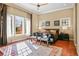 Inviting bedroom filled with natural light, hardwood floors, a large window, and an area rug at 26 Royal Ann Dr, Greenwood Village, CO 80111