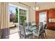 Dining room with glass table, outside deck access, and view of the yard at 26 Royal Ann Dr, Greenwood Village, CO 80111