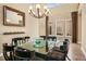 Elegant dining room with a large table, chandelier, and plenty of natural light from surrounding windows at 26 Royal Ann Dr, Greenwood Village, CO 80111