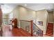 Hallway with wood floors, piano, staircase and natural light at 26 Royal Ann Dr, Greenwood Village, CO 80111