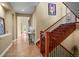 Hallway featuring wooden staircase with black iron railing and tiled flooring at 26 Royal Ann Dr, Greenwood Village, CO 80111