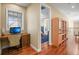 Bright home office with wood floors, built-in desk, and natural light from the window at 26 Royal Ann Dr, Greenwood Village, CO 80111