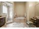 Luxurious main bathroom featuring a soaking tub, walk-in shower, and vanity area at 26 Royal Ann Dr, Greenwood Village, CO 80111