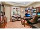 Spacious home office with built-in bookshelves, a large desk, and natural light at 26 Royal Ann Dr, Greenwood Village, CO 80111