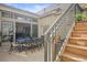 Outdoor patio featuring a dining table and stairs to additional outdoor space at 26 Royal Ann Dr, Greenwood Village, CO 80111