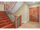 Beautiful wooden staircase with wrought iron railing and tiled flooring at 26 Royal Ann Dr, Greenwood Village, CO 80111