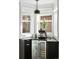Contemporary bar area featuring a wine fridge, dark cabinets, and stylish pendant lighting near bay window at 2515 Zenobia St, Denver, CO 80212