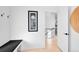 Stylish entryway with a bench, modern art, and an open doorway leading to the home's interior at 2515 Zenobia St, Denver, CO 80212