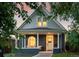 Charming home with a painted brick exterior, covered porch, and manicured front yard at 2515 Zenobia St, Denver, CO 80212