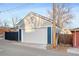 Detached two-car garage with white door and siding at 2515 Zenobia St, Denver, CO 80212